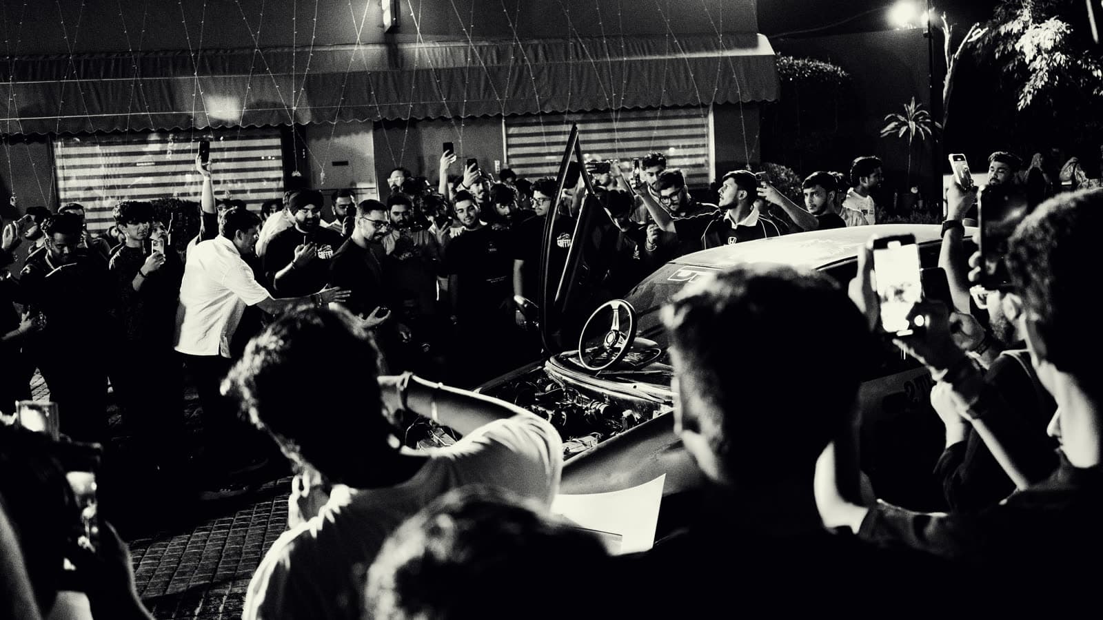 Black and white crowd at a car culture event
