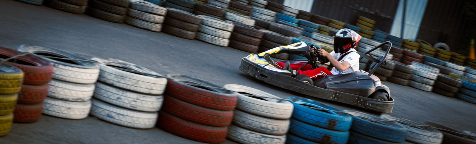 Go-kart cornering past a tyre wall